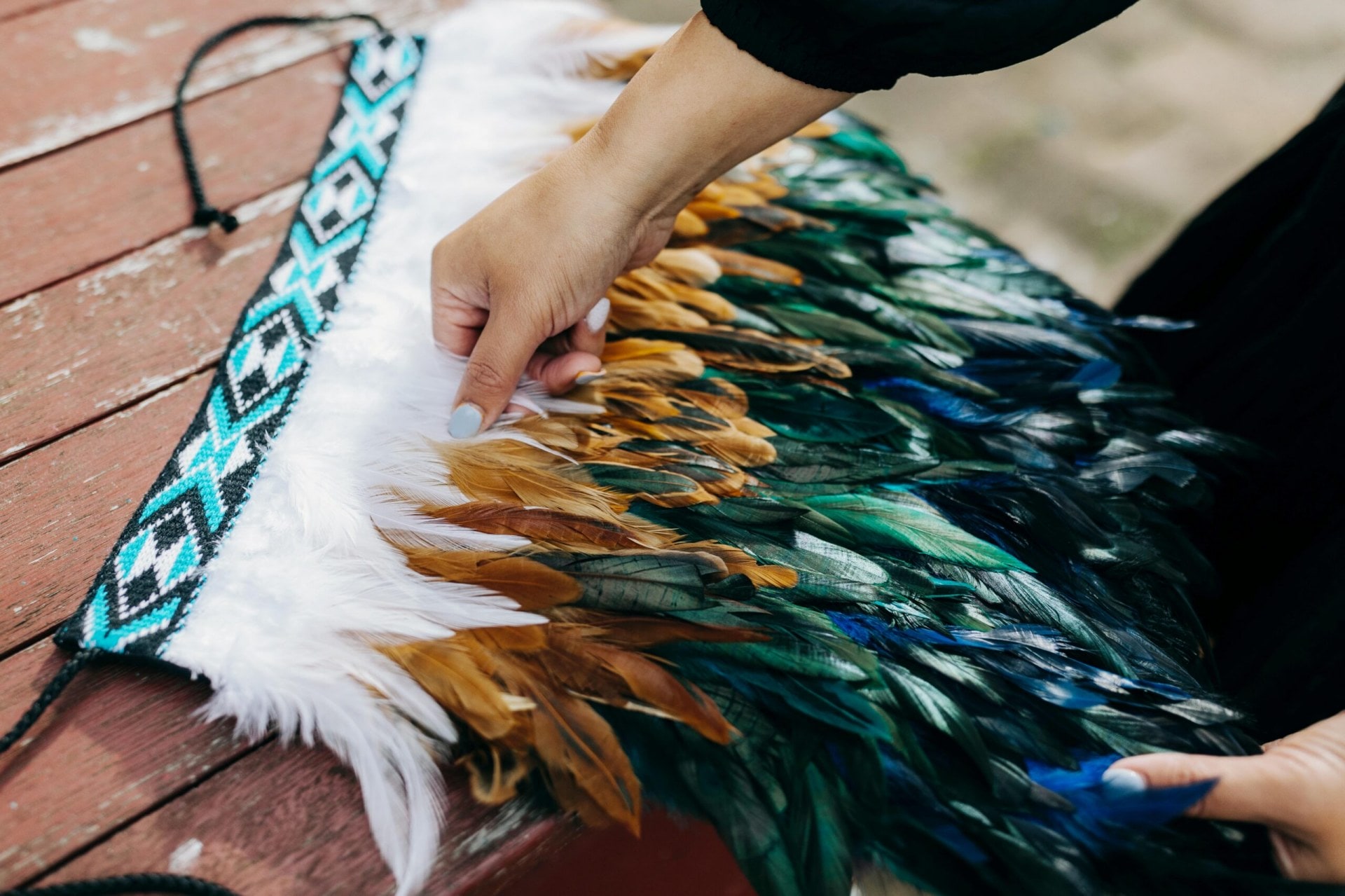 A green and white Kids Korowai cloak being created