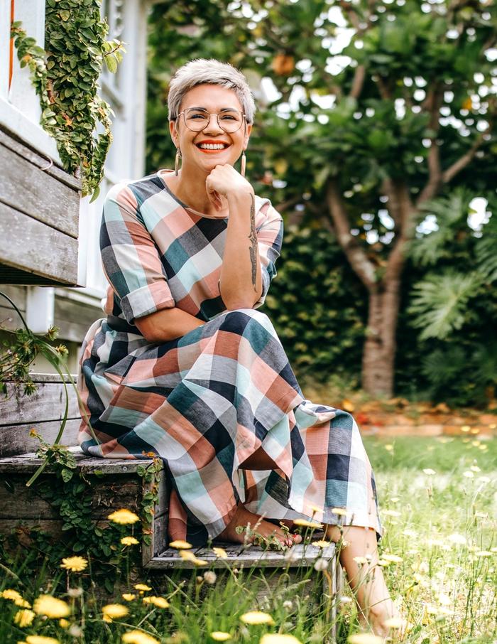 Emma Espiner sitting on steps by yard