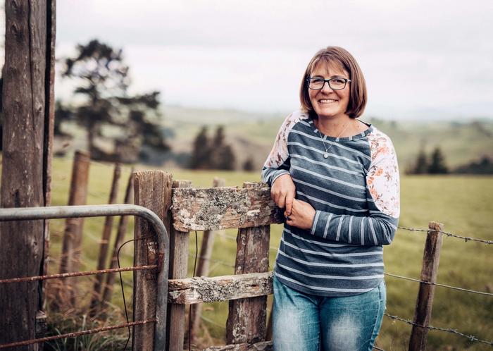 Danielle Hawkins leans against a fence