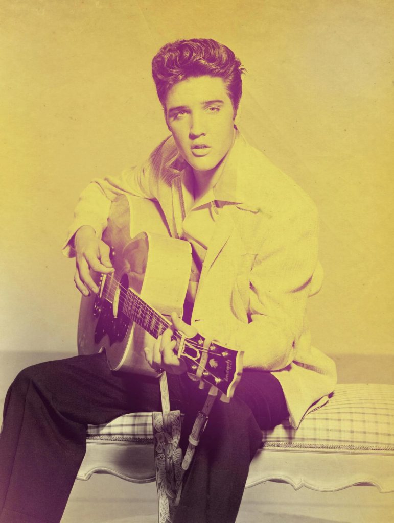 Elvis Presley playing guitar.