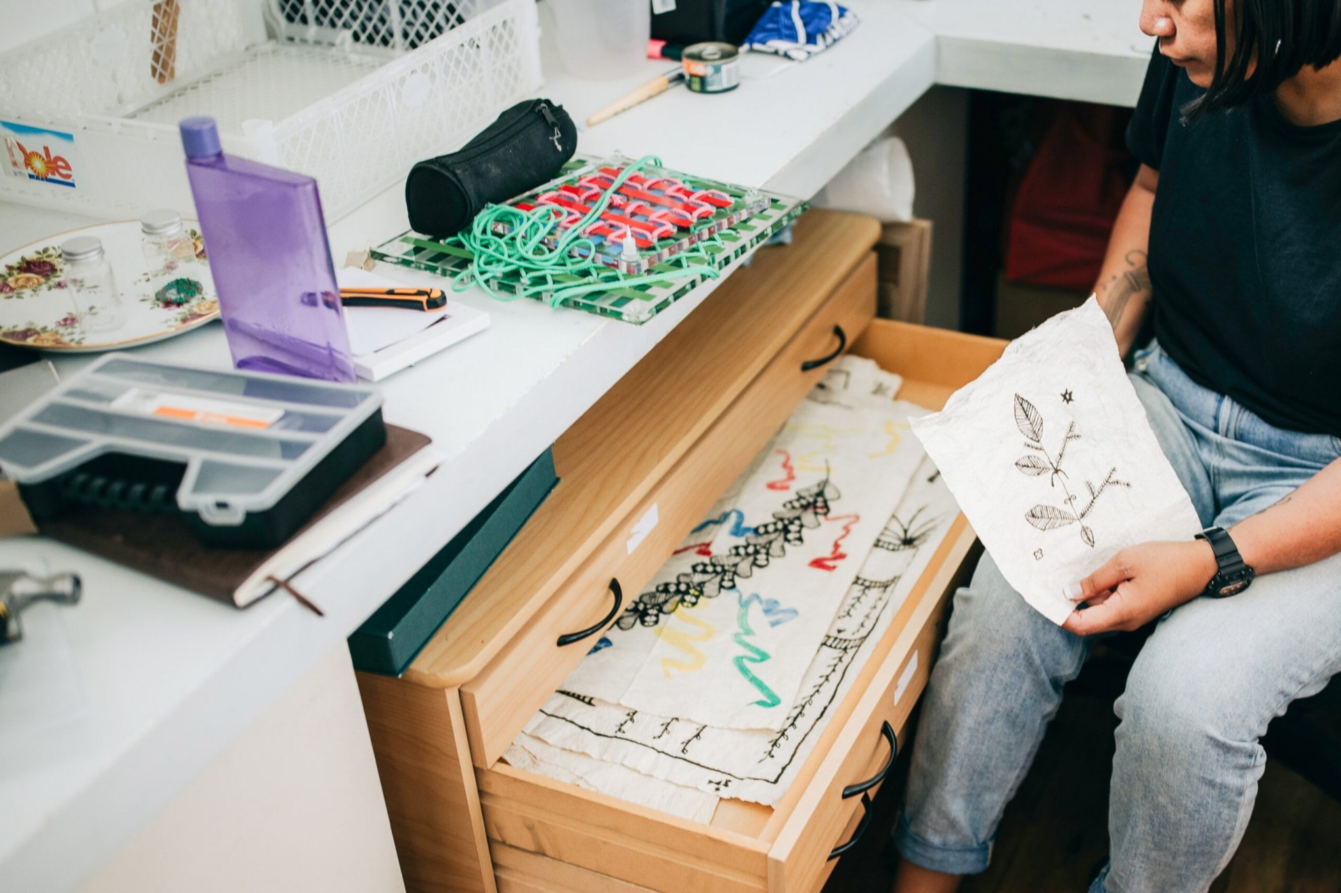 Cora-Allan Wickliffe showing a drawer full of art