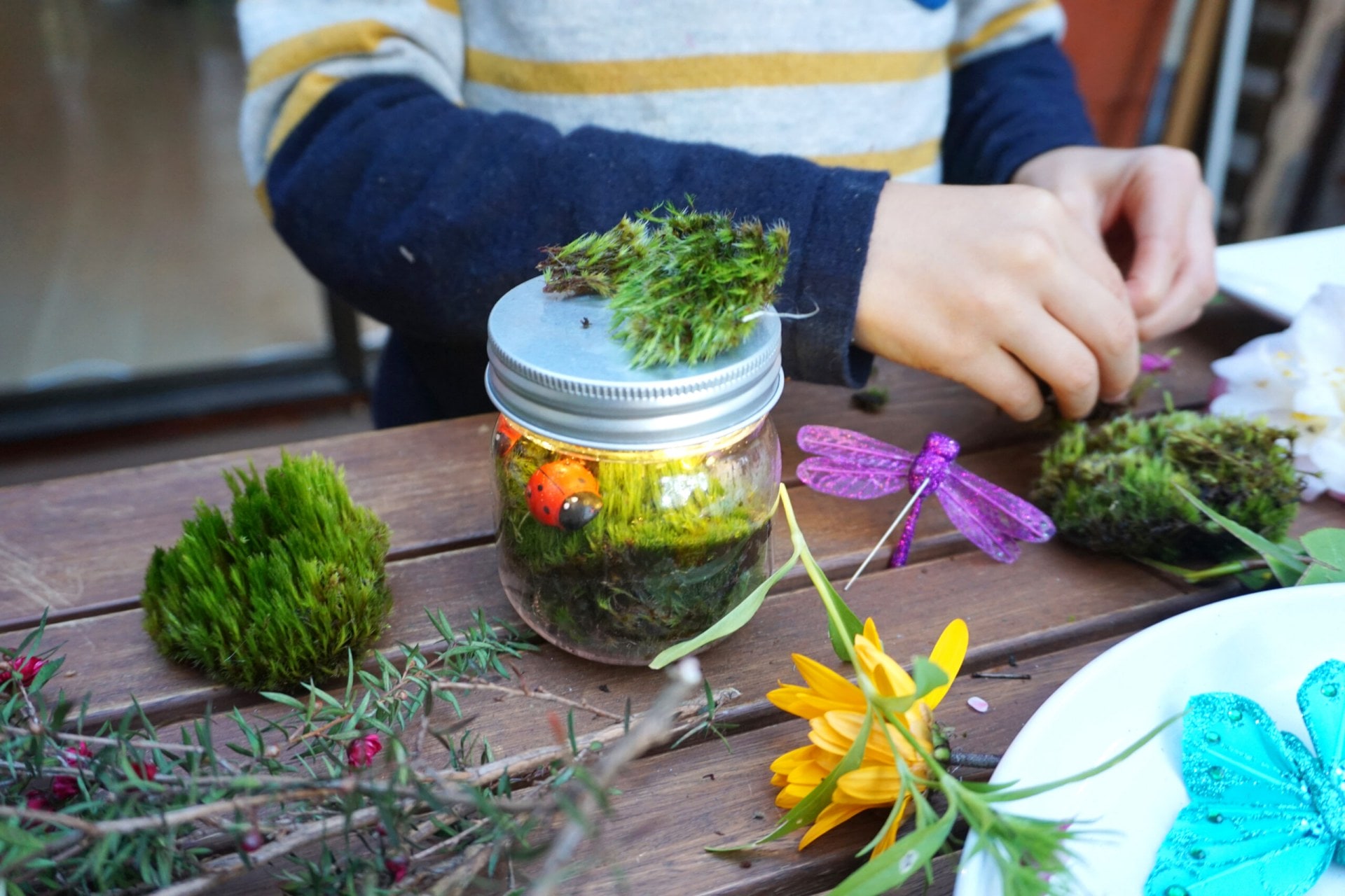 A jar filled with fairy lights and touches of nature