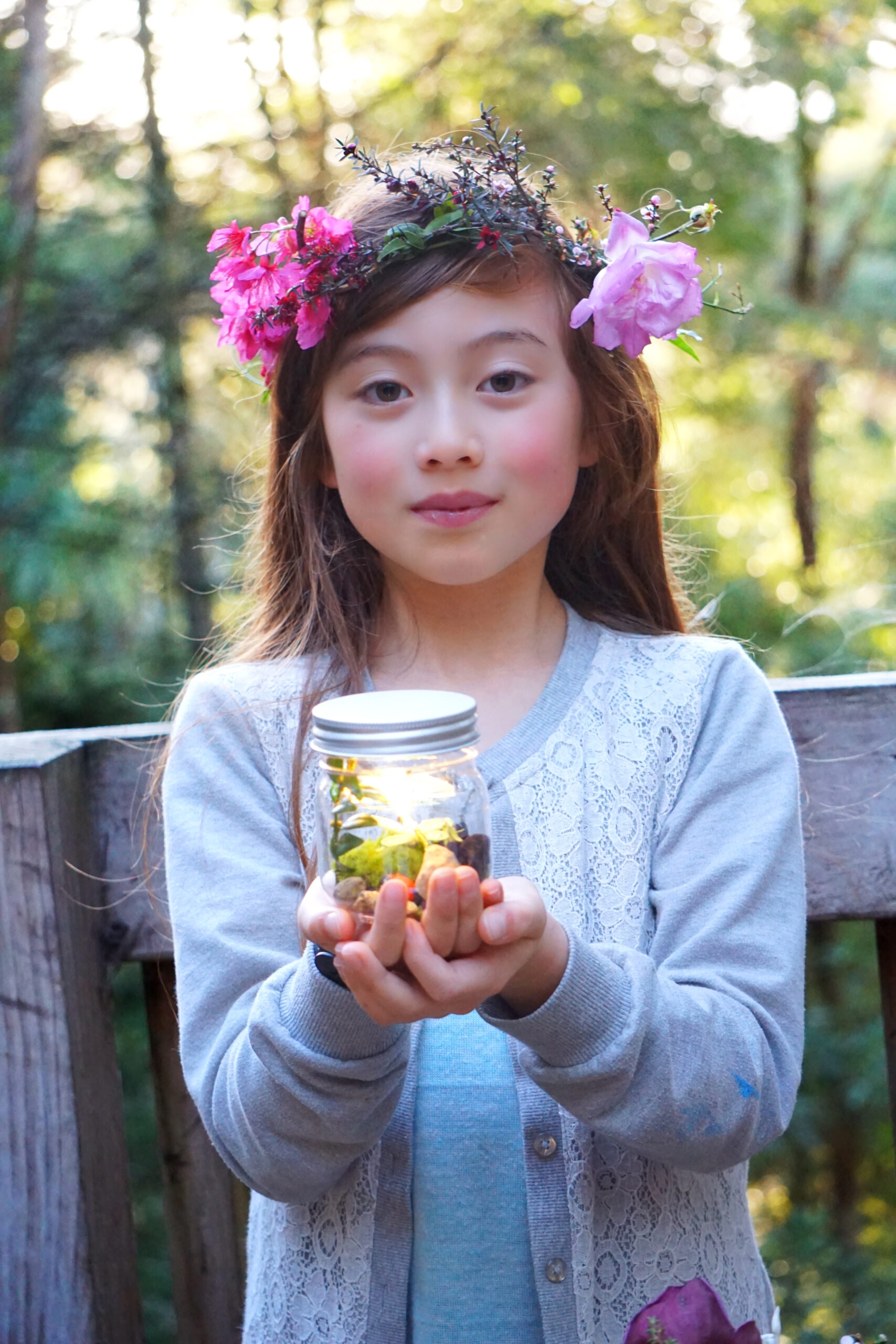 Little girl wearing flower crown holding a fairy lantern