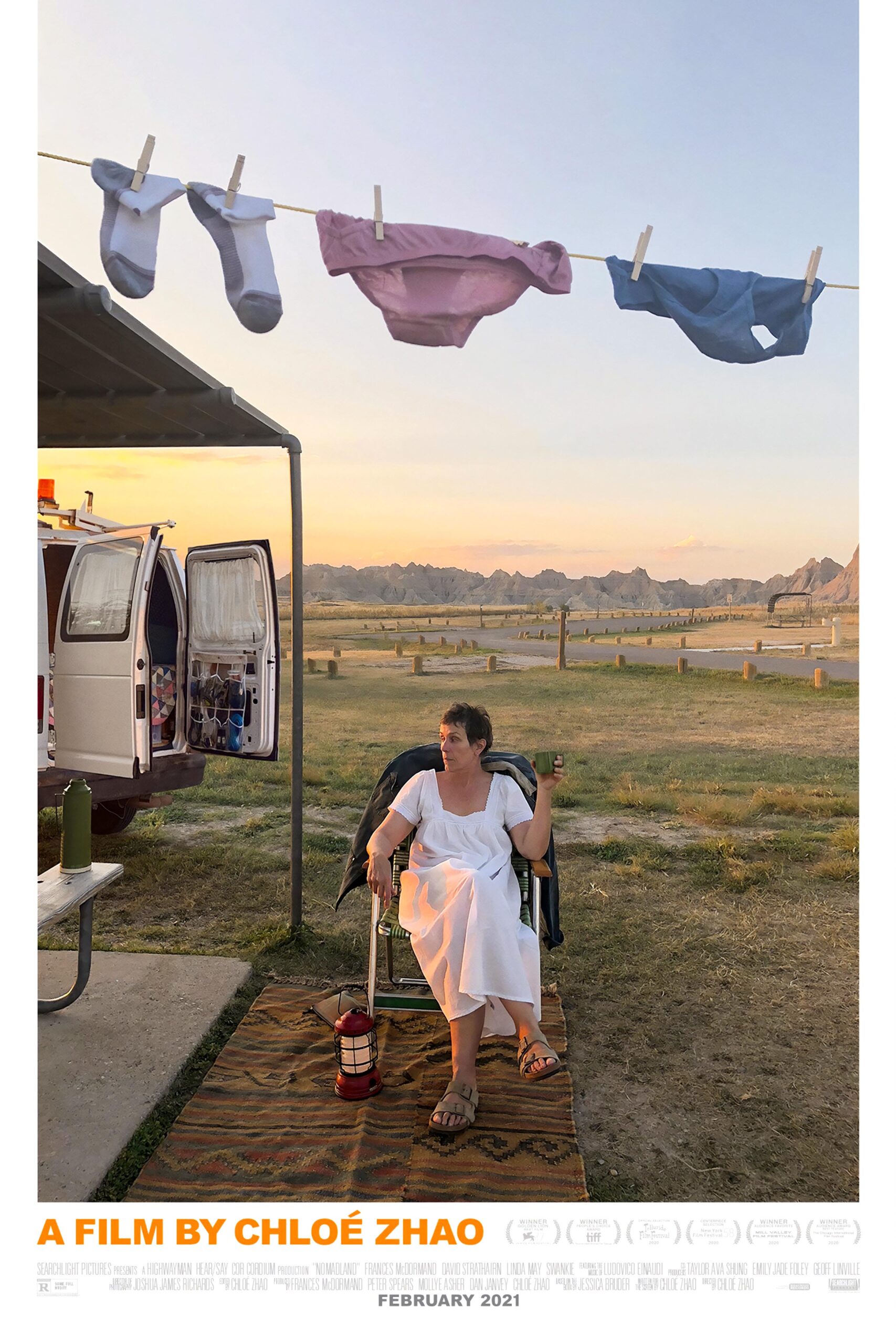 Poster for Nomadland showing Frances McDormand sitting outside an RV