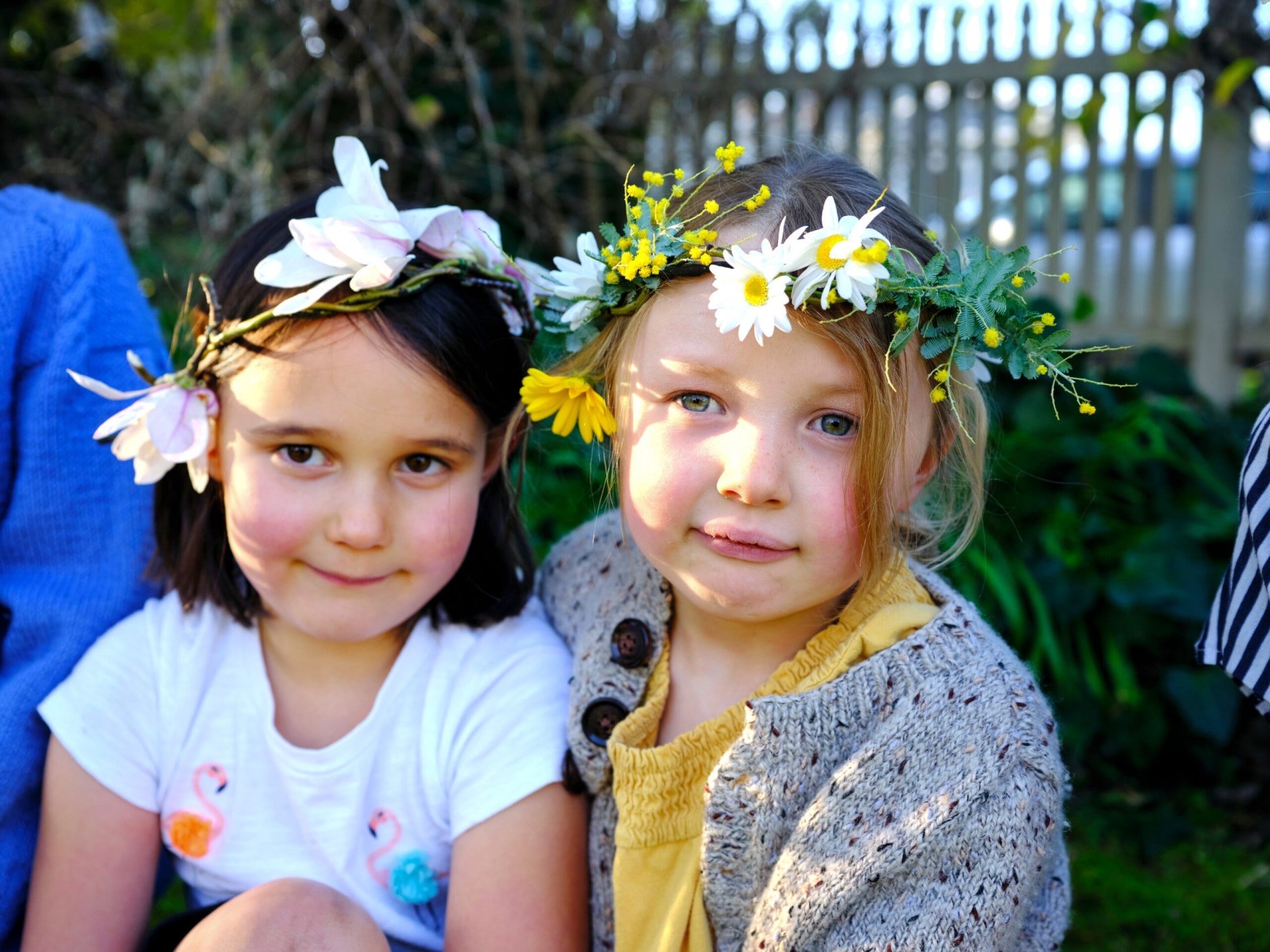 Two girls wearing flower crowns 