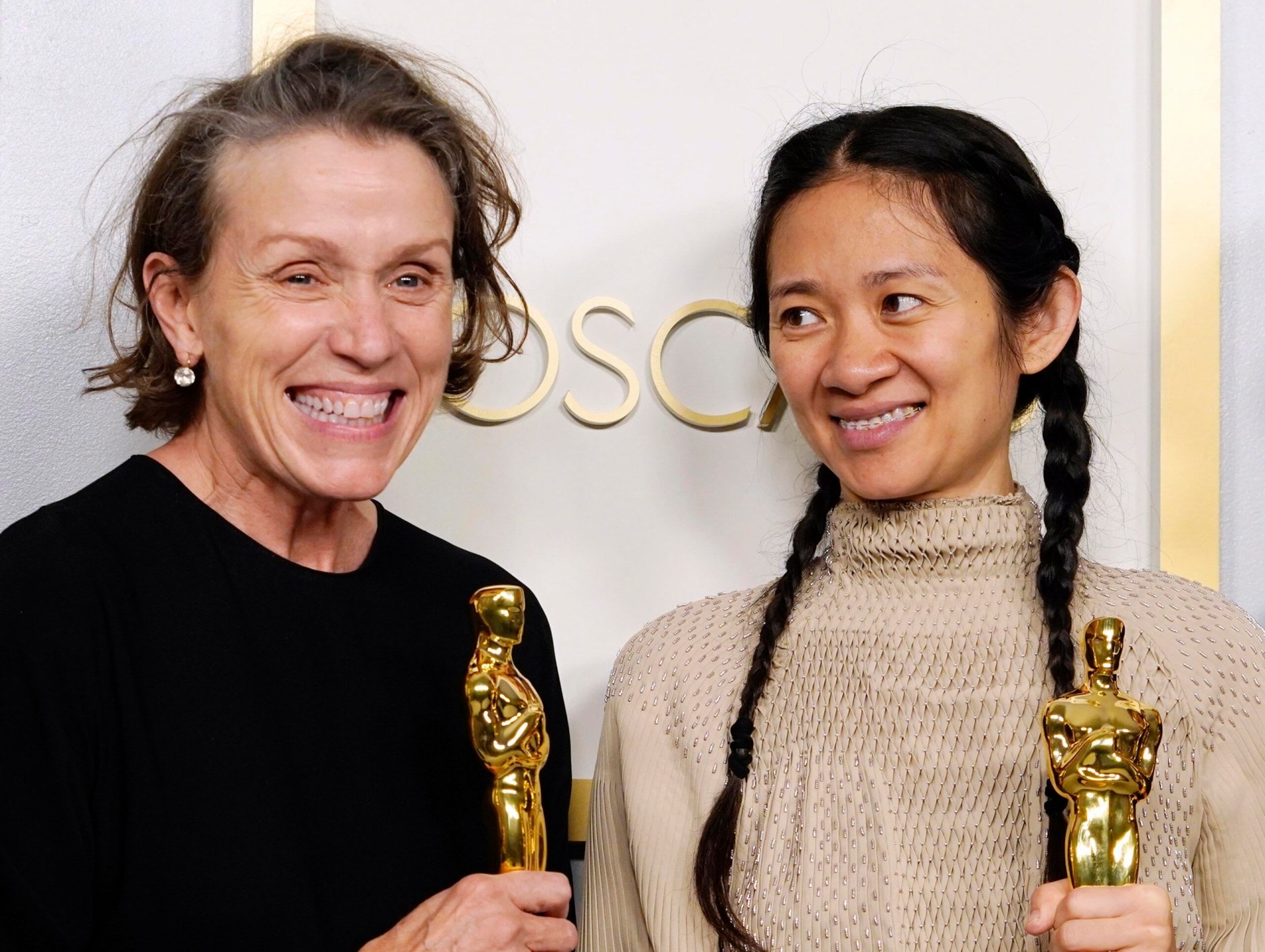 Frances McDormand and Chloé Zhao holding Oscars at the Oscars Ceremony