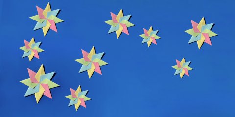 Colourful paper stars against a blue background