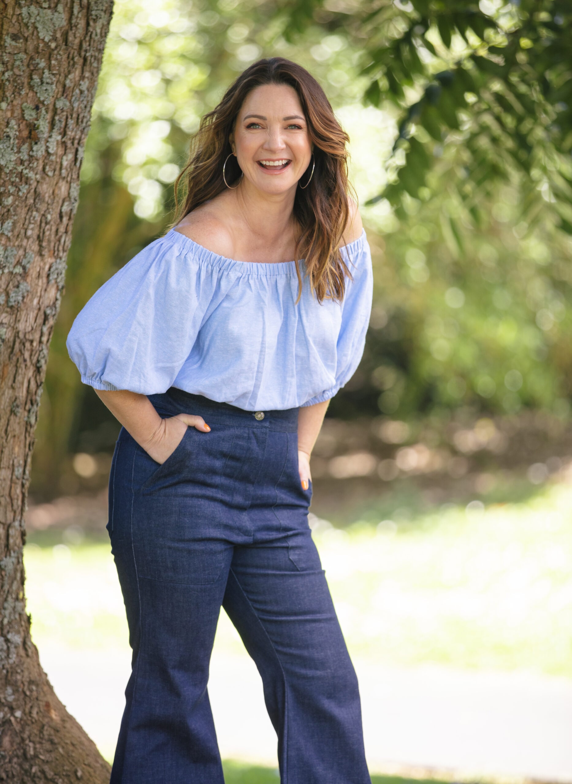 Claire Chitham laughing while wearing blue top 