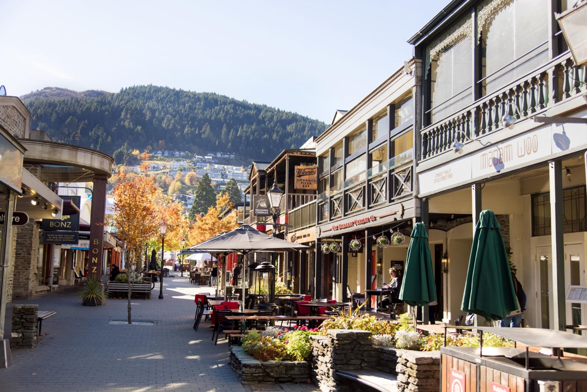 The Mall at Queenstown showing various shops and a large hill in the background