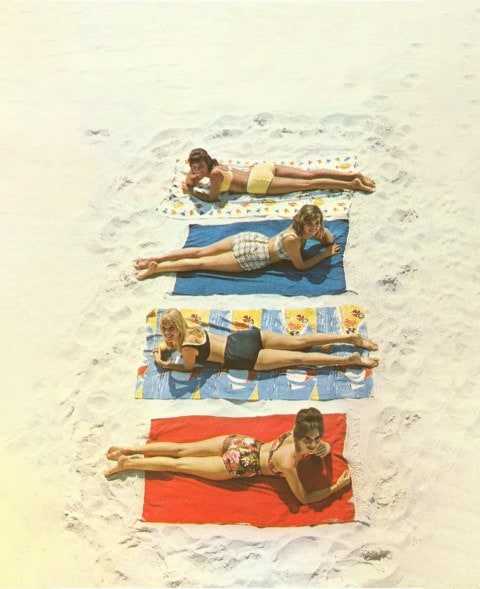 Vintage photo of four women lying on beach