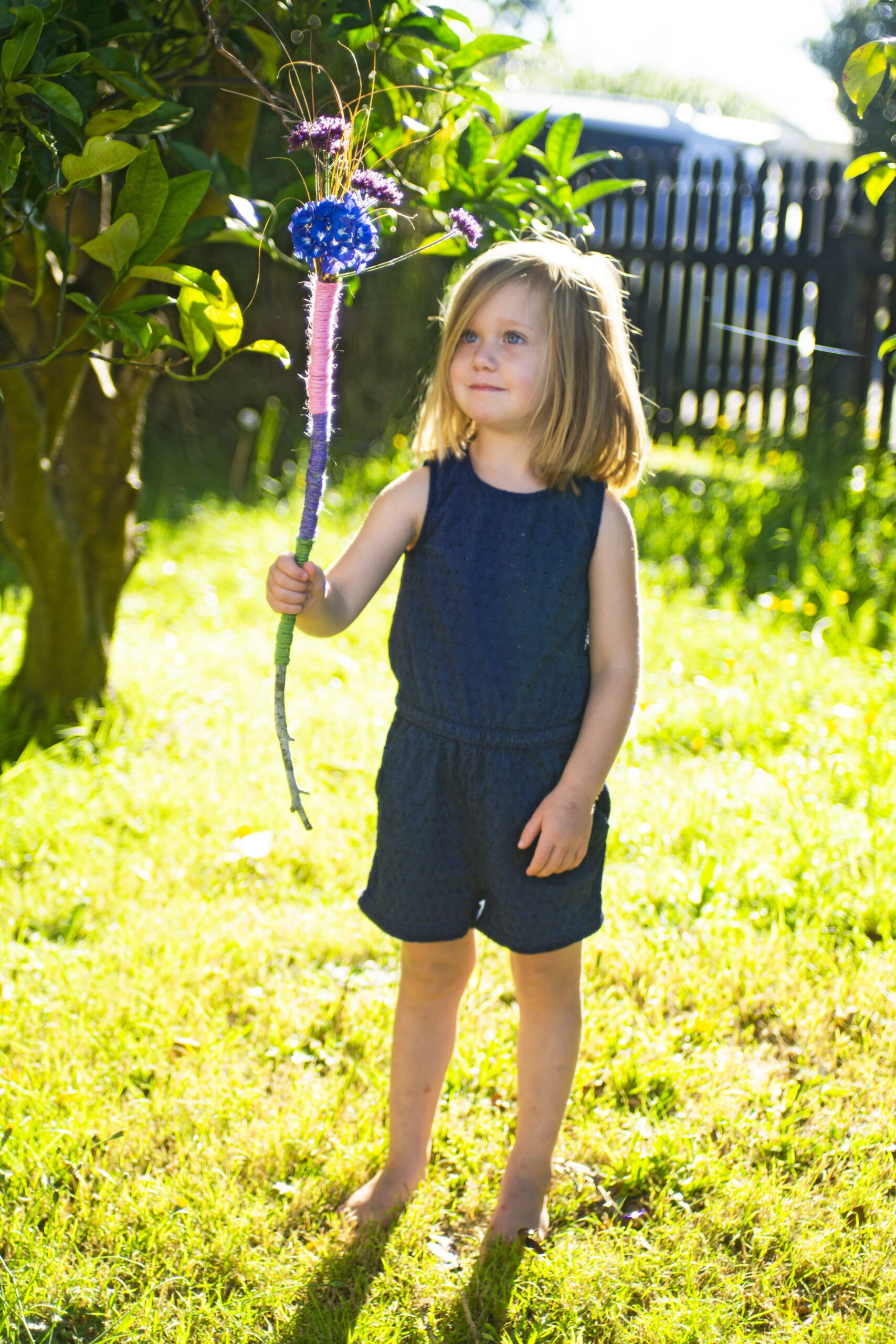 Little girl holding nature wand 