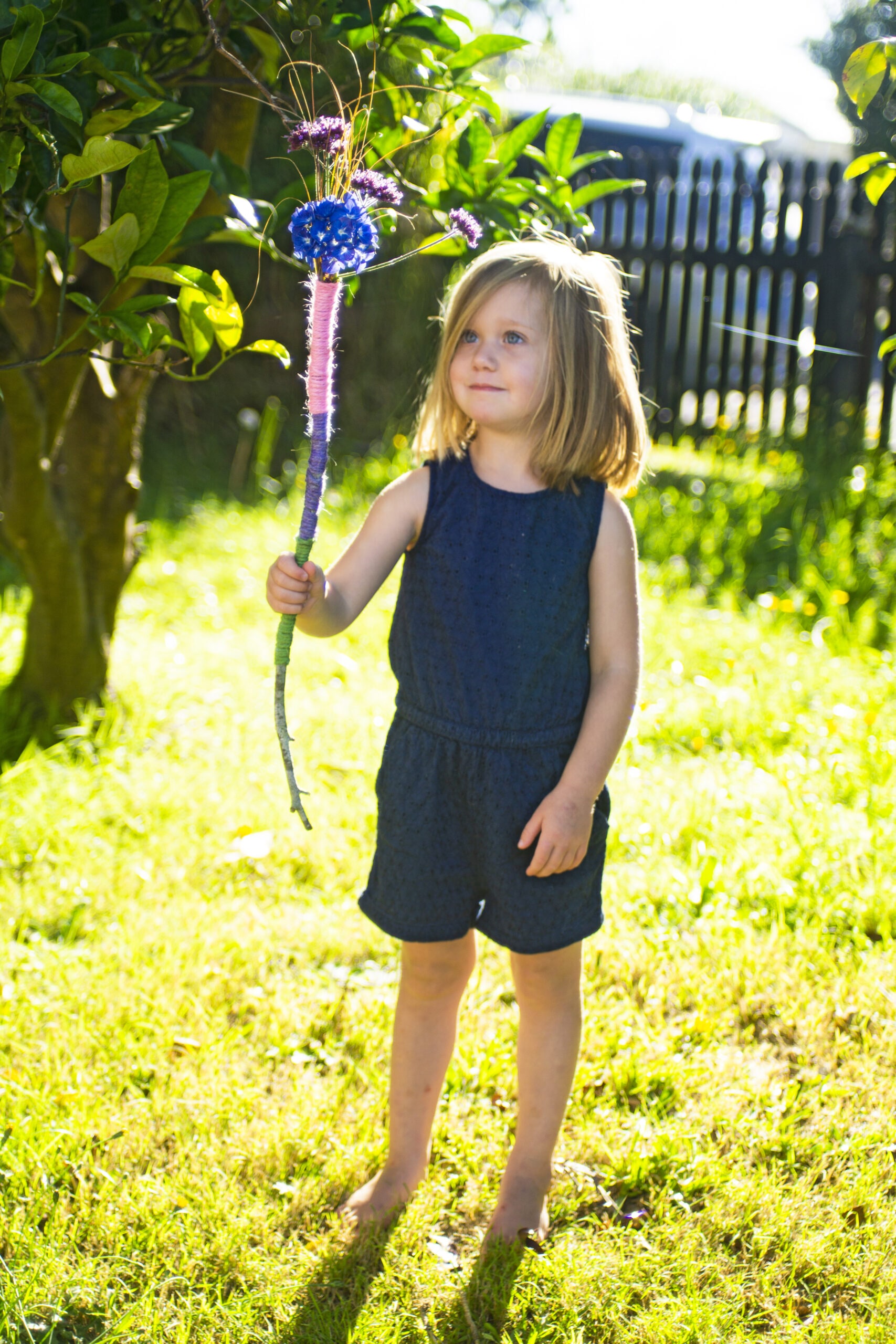 Little girl holding nature wand