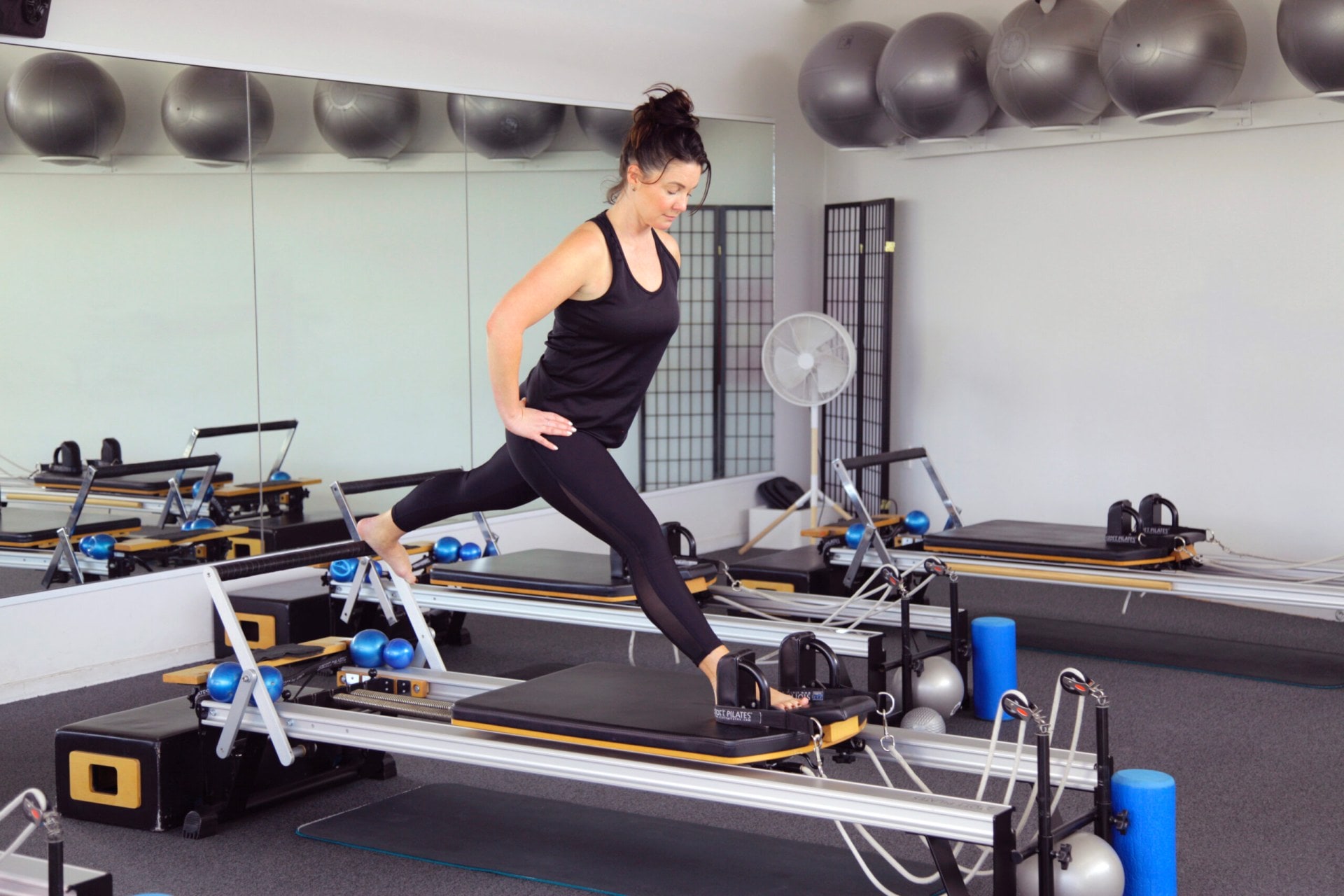 Claire Chitham doing pilates on a pilates machine