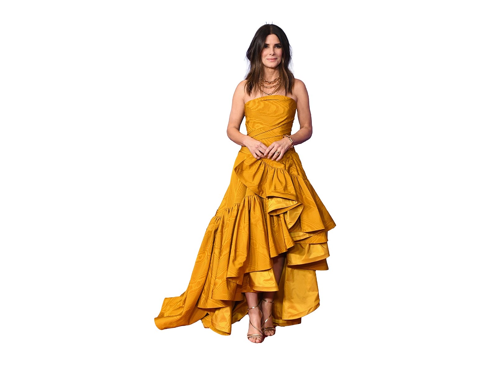 Sandra Bullock wearing a long layered mustard yellow dress 