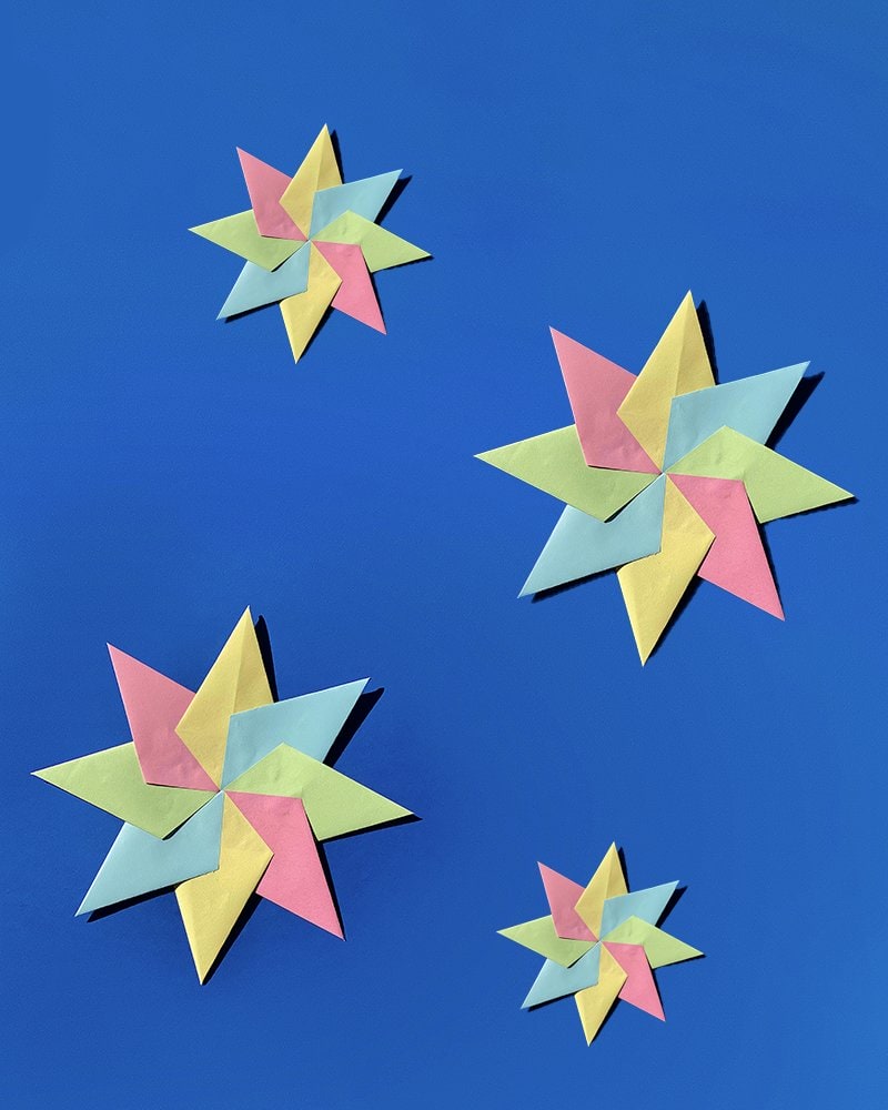 Colourful paper stars on a blue background