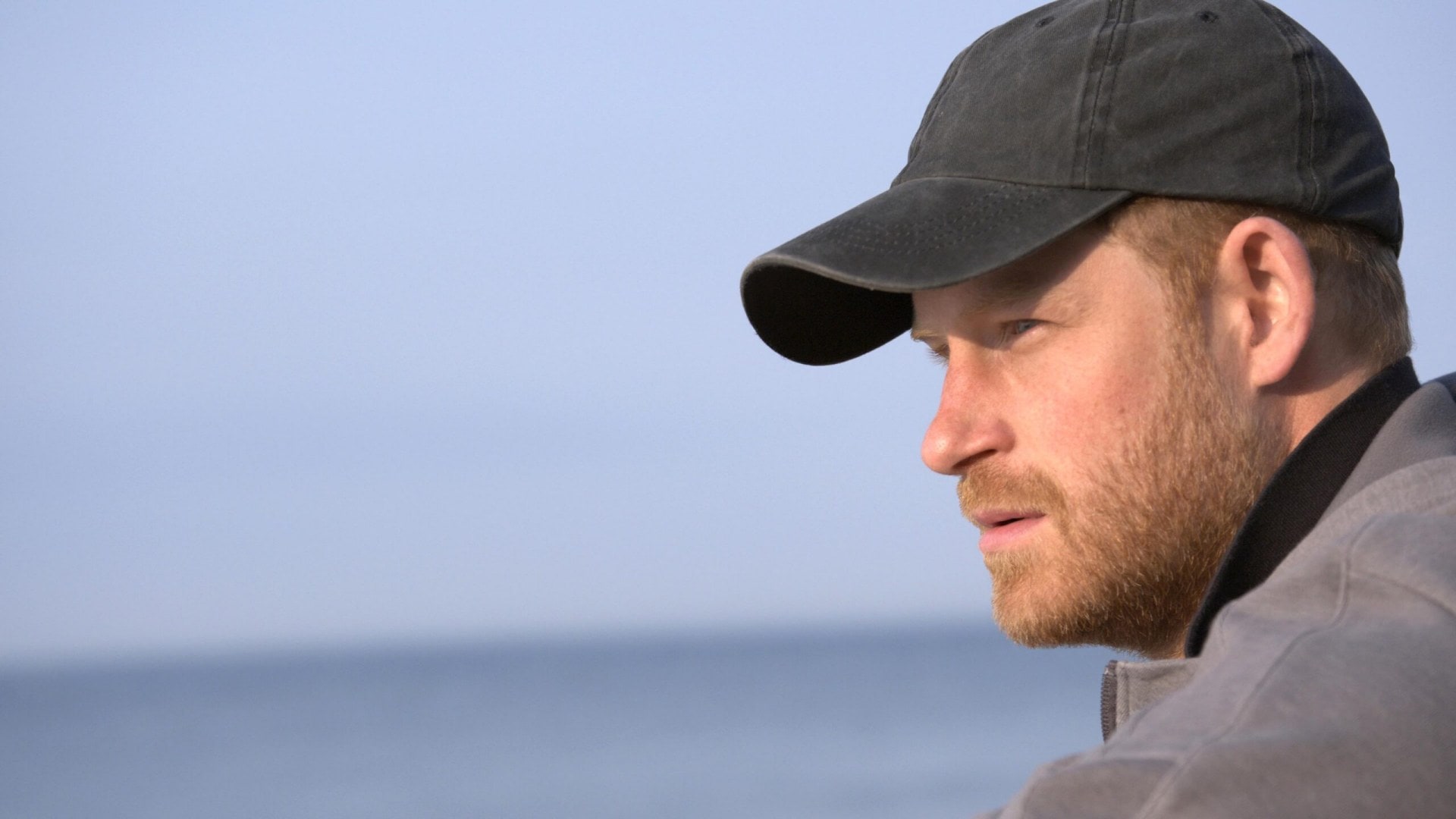 Prince Harry wearing a cap looking at the ocean in The Me You Can't See