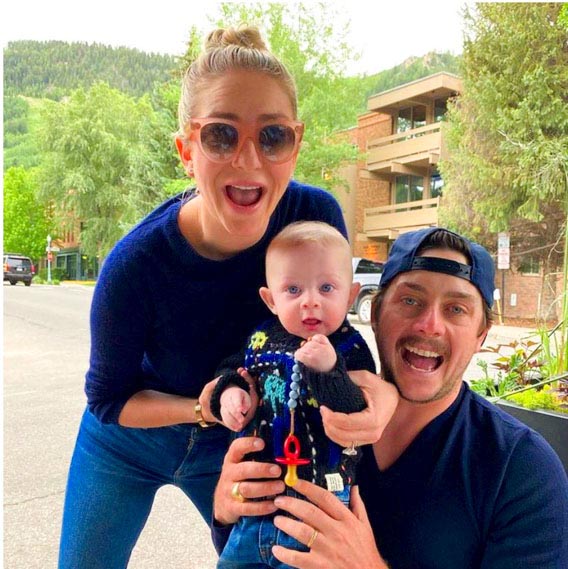 Whitney Wolfe Herd holding her son Bobby with husband Michael
