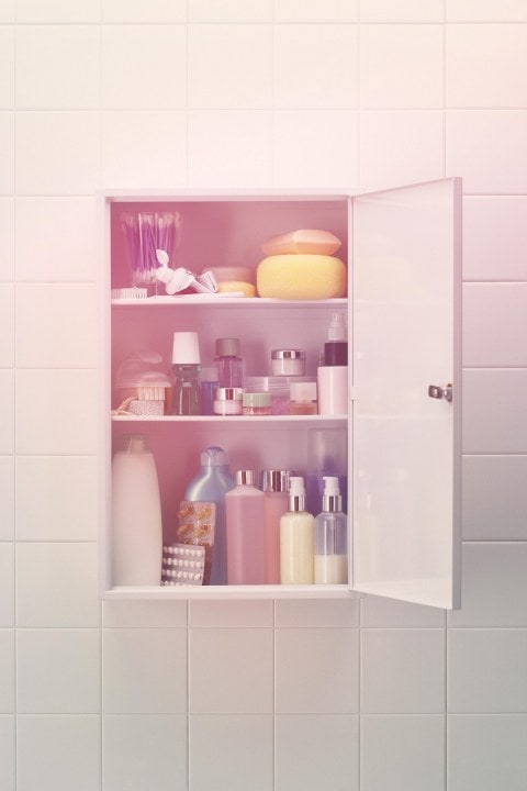 An open cabinet full of beauty products.