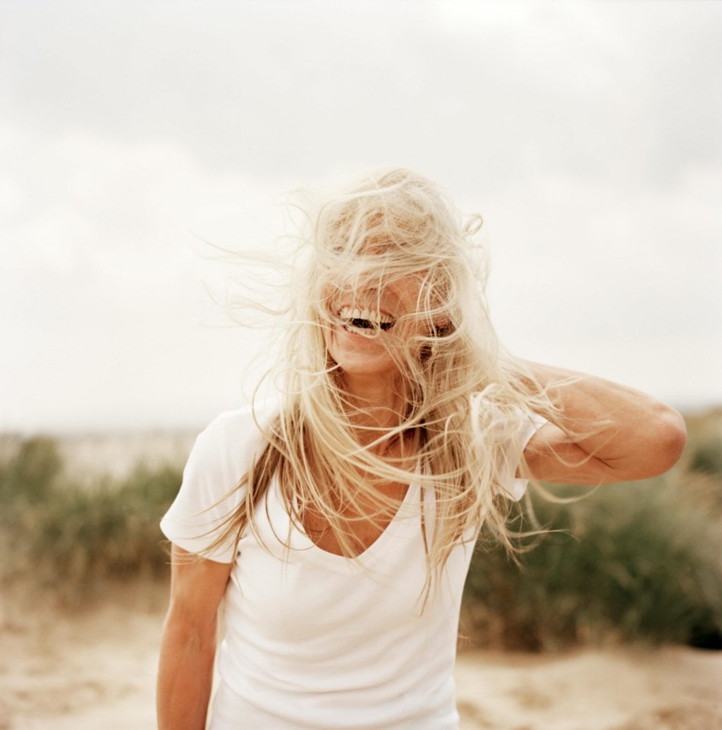 older woman with long hair blowing in the wind