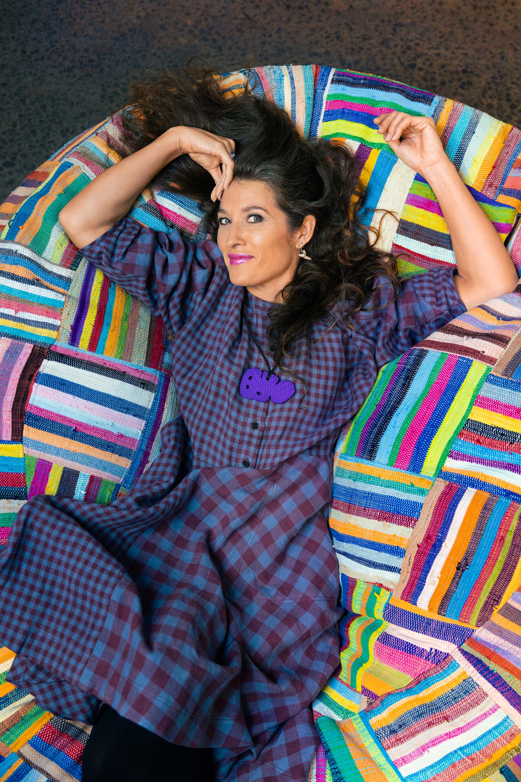 Chelsea Winstanley lying on a colourful mat