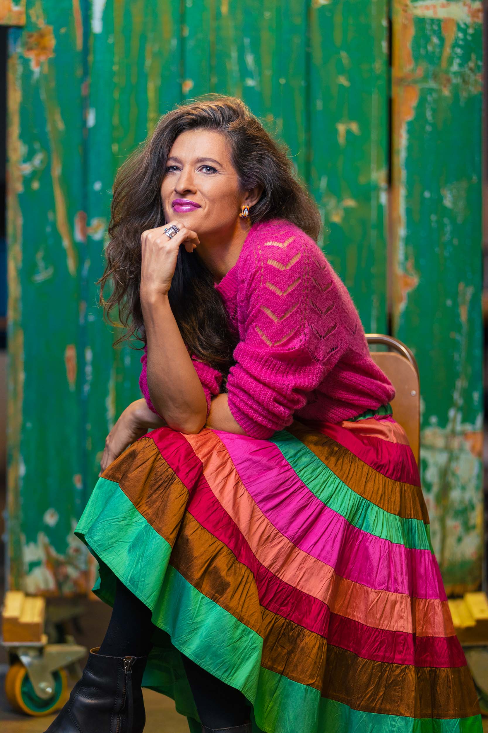 Chelsea Winstanley in a pink jumper and colourful skirt