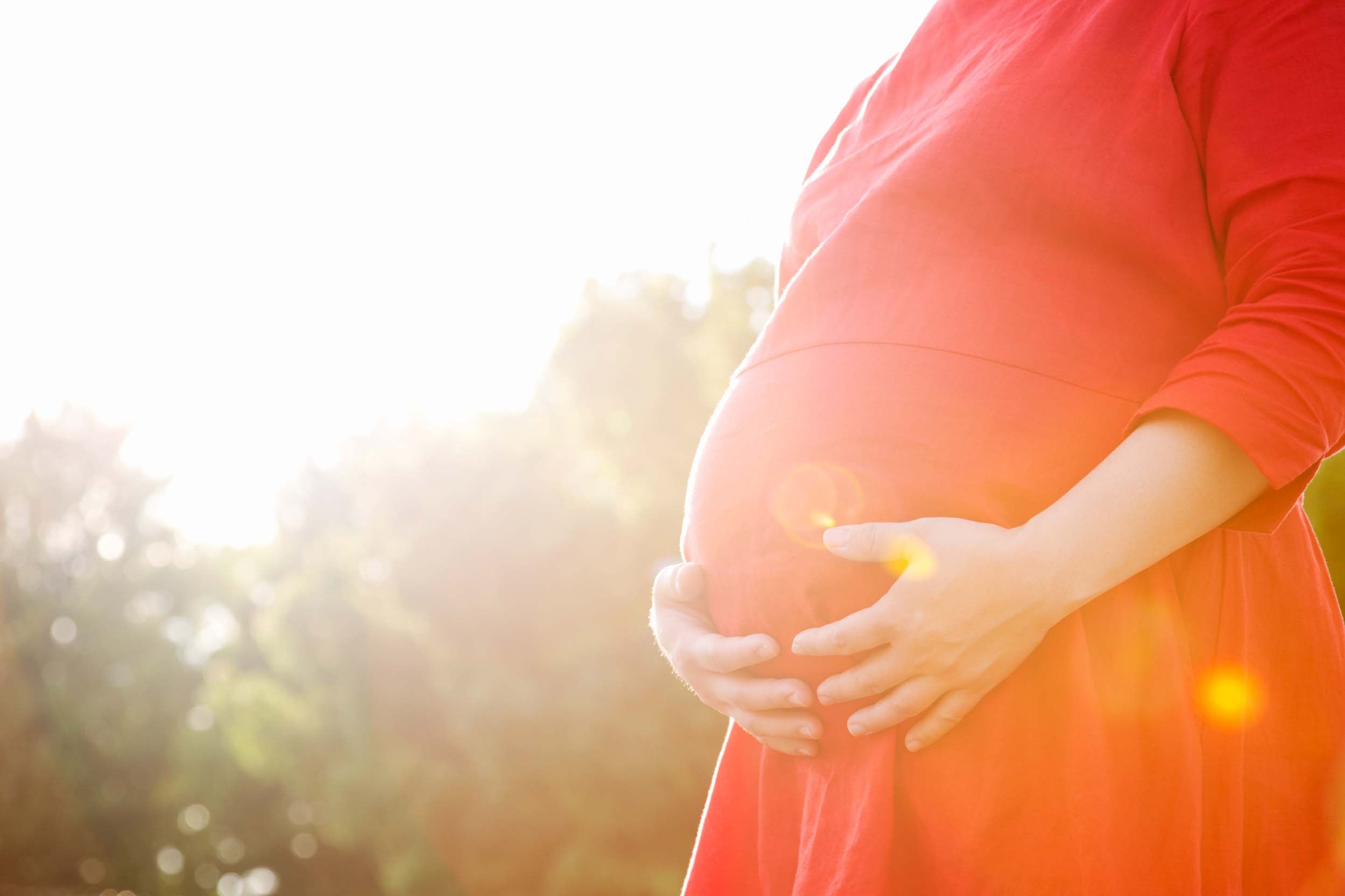 a pregnant woman in a red dress