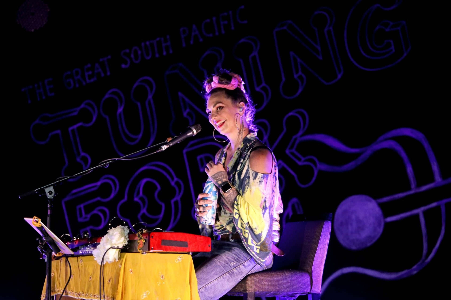 Hollie Smith sitting in front of a keyboard and microphone