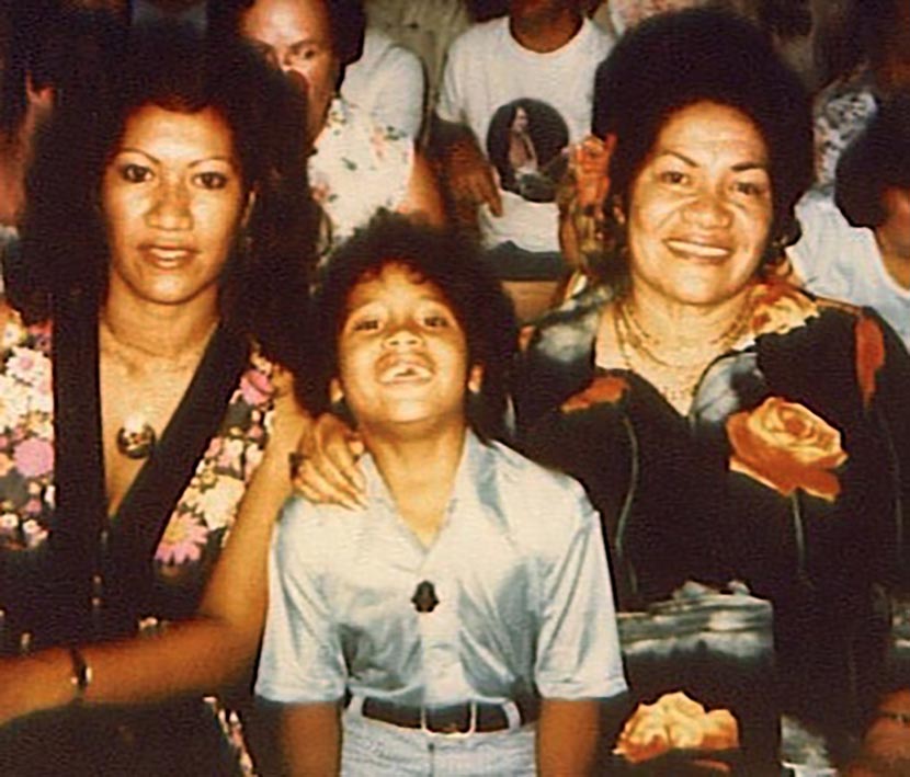 A young Dwayne The Rock Johnson laughing while sitting next to his mother Ata and Grandmother