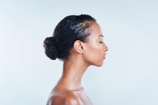 Studio shot of a beautiful young woman posing against a plain background