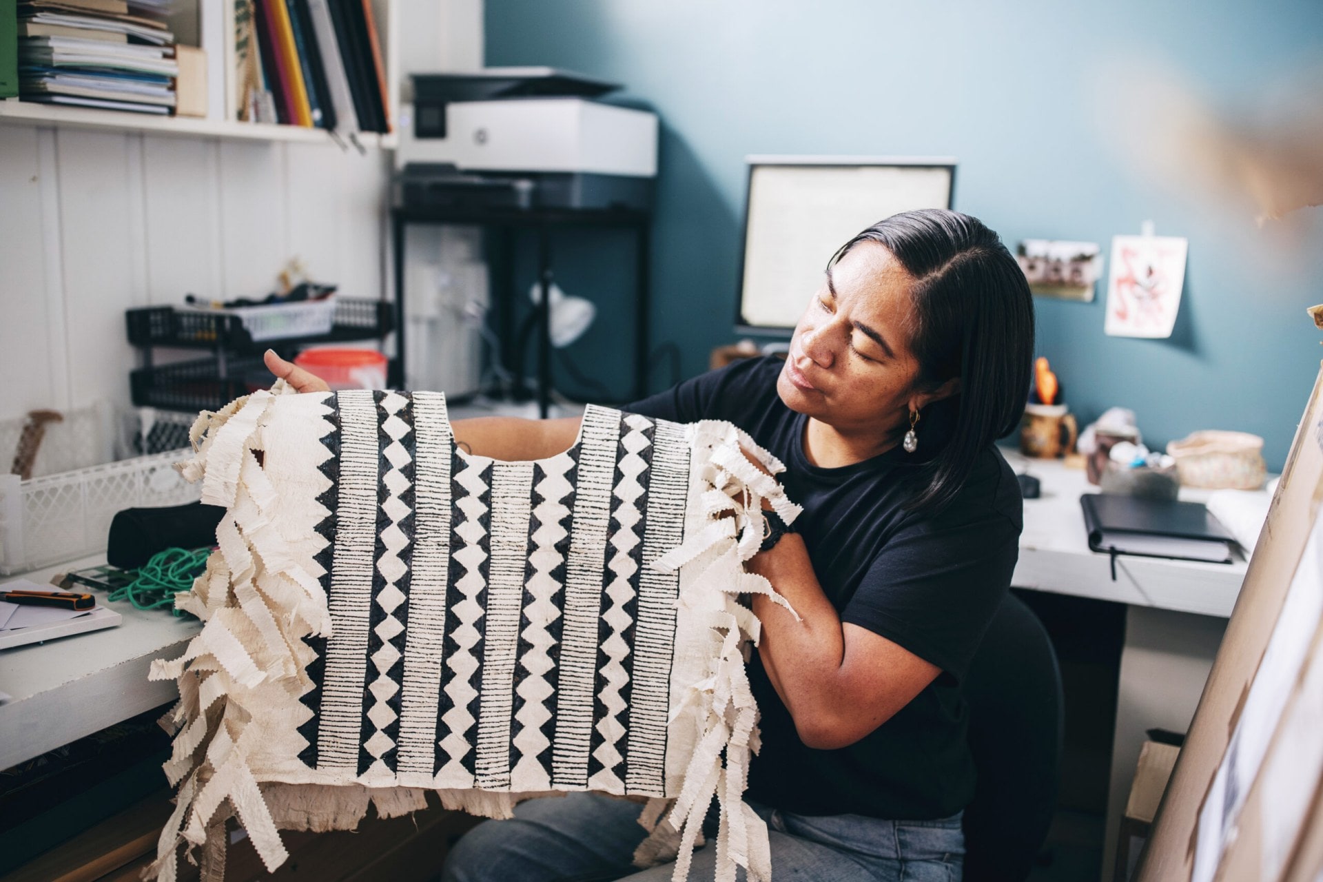 Cora-Allan Wickliffe holding a hiapo top