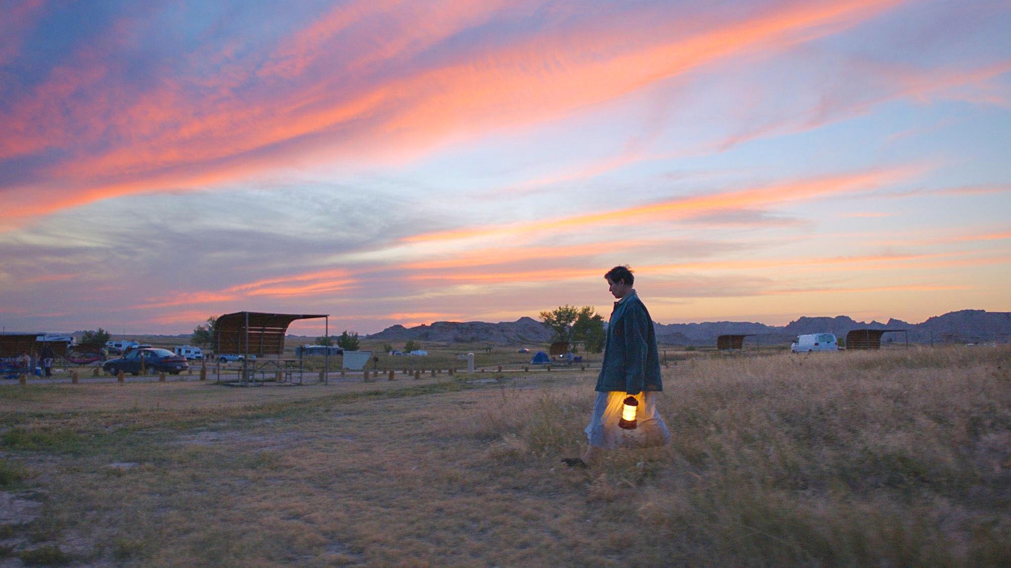 Frances McDormand standing outside an RV in Nomadland