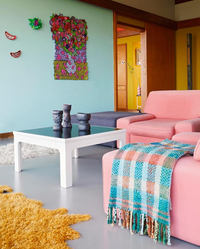 Living room with green walls and pink couch