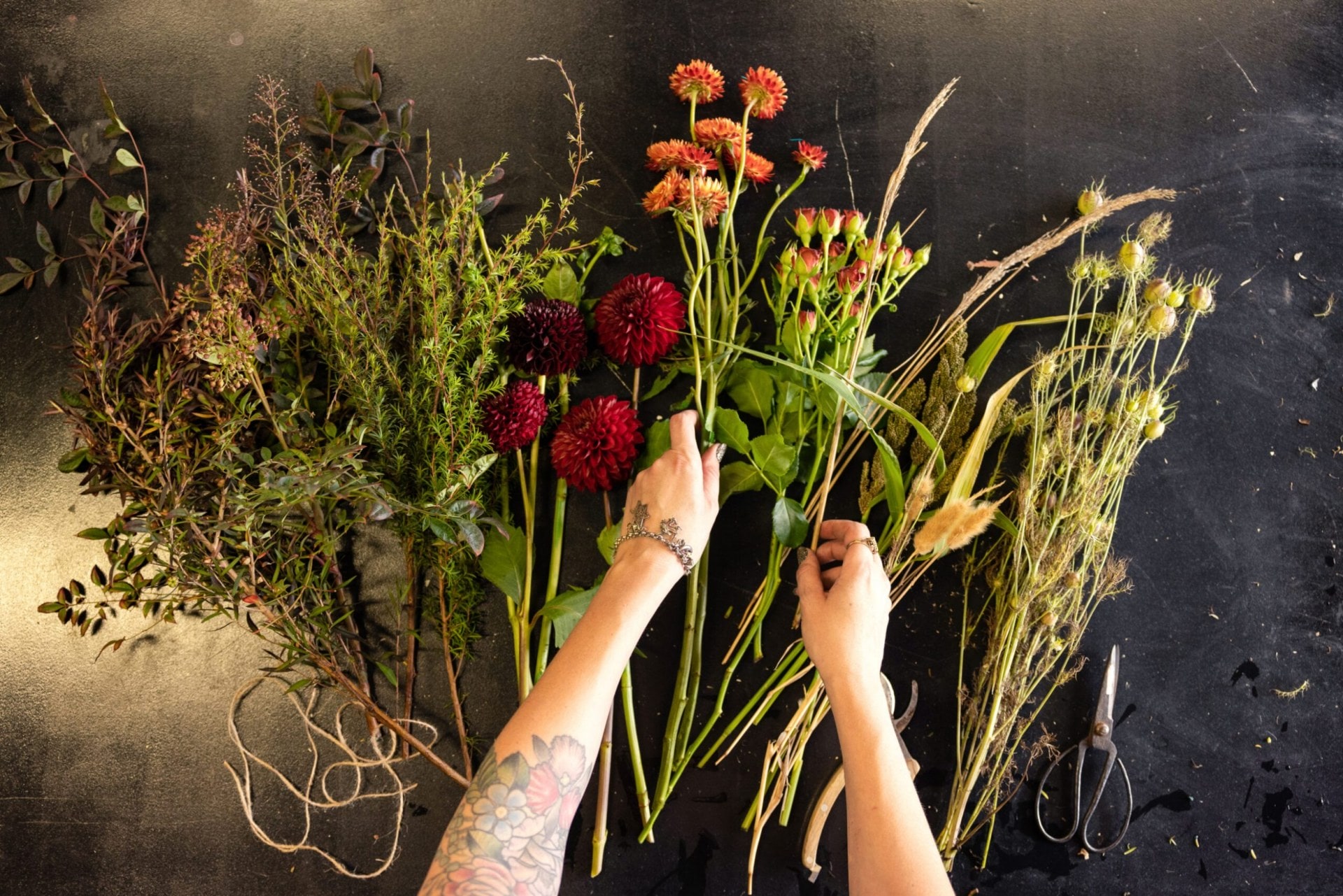 Assortment of branches and flowers on a black table