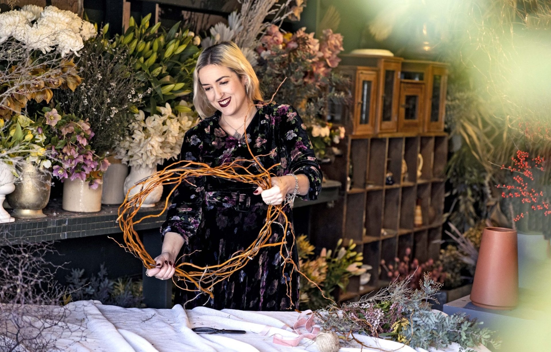 Georgie Malyon holding a wreath circle made out of willow stems