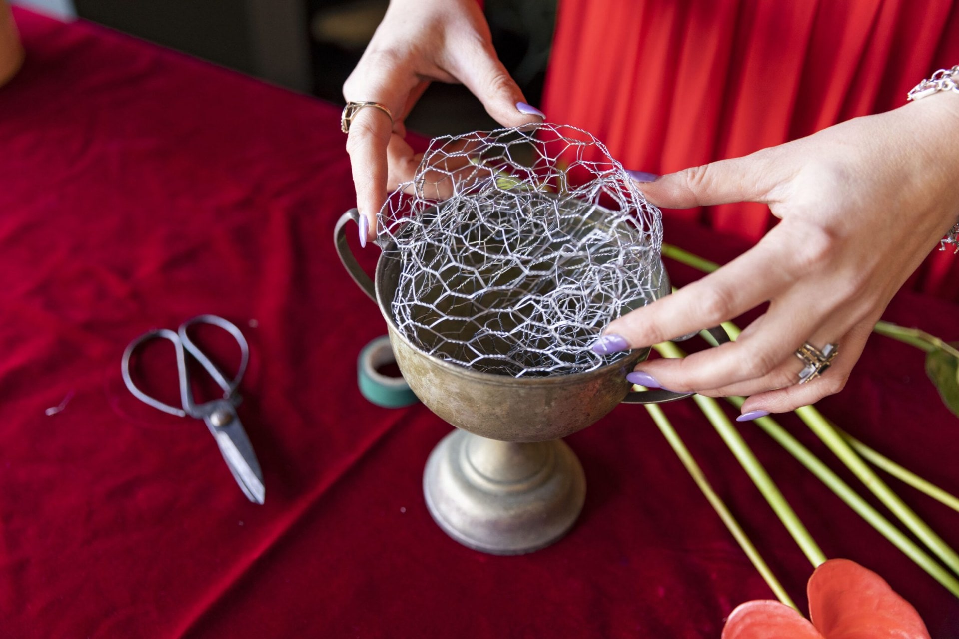 A ball of chicken wire mesh being placed in an urn