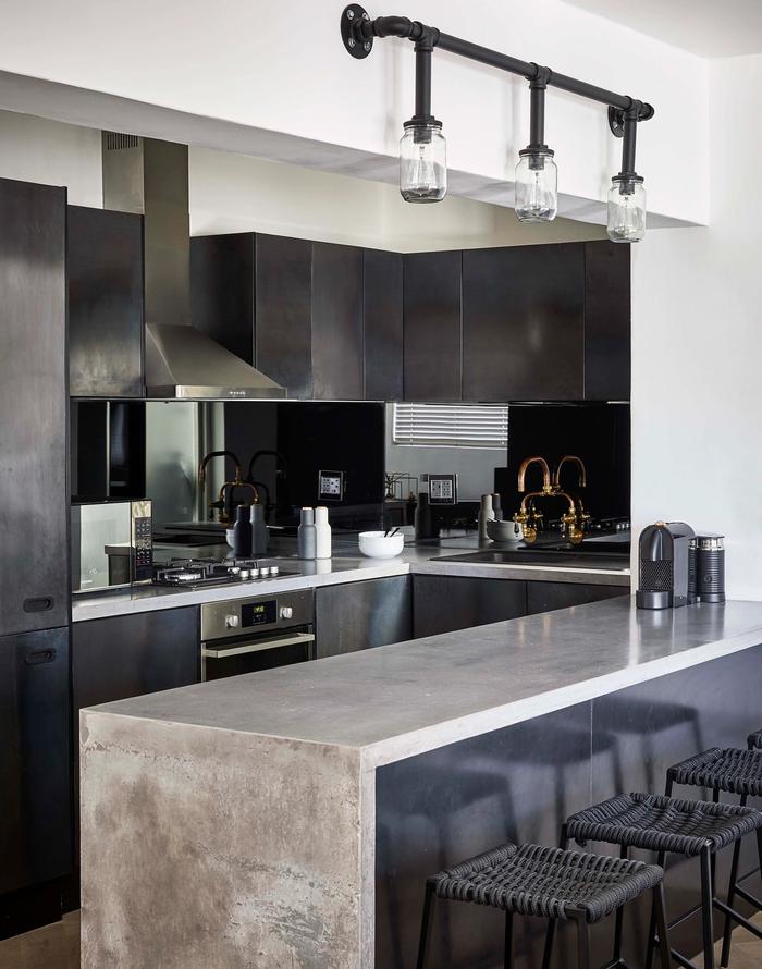 A black kitchen with grey marble benchtops