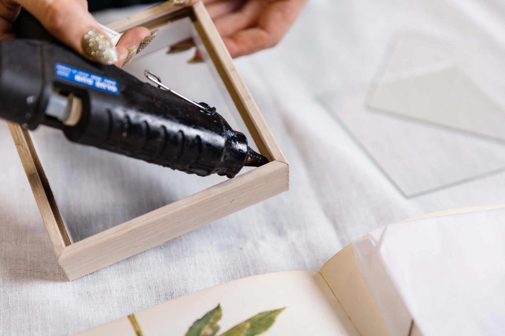 Glue being applied to a corner of a wood frame