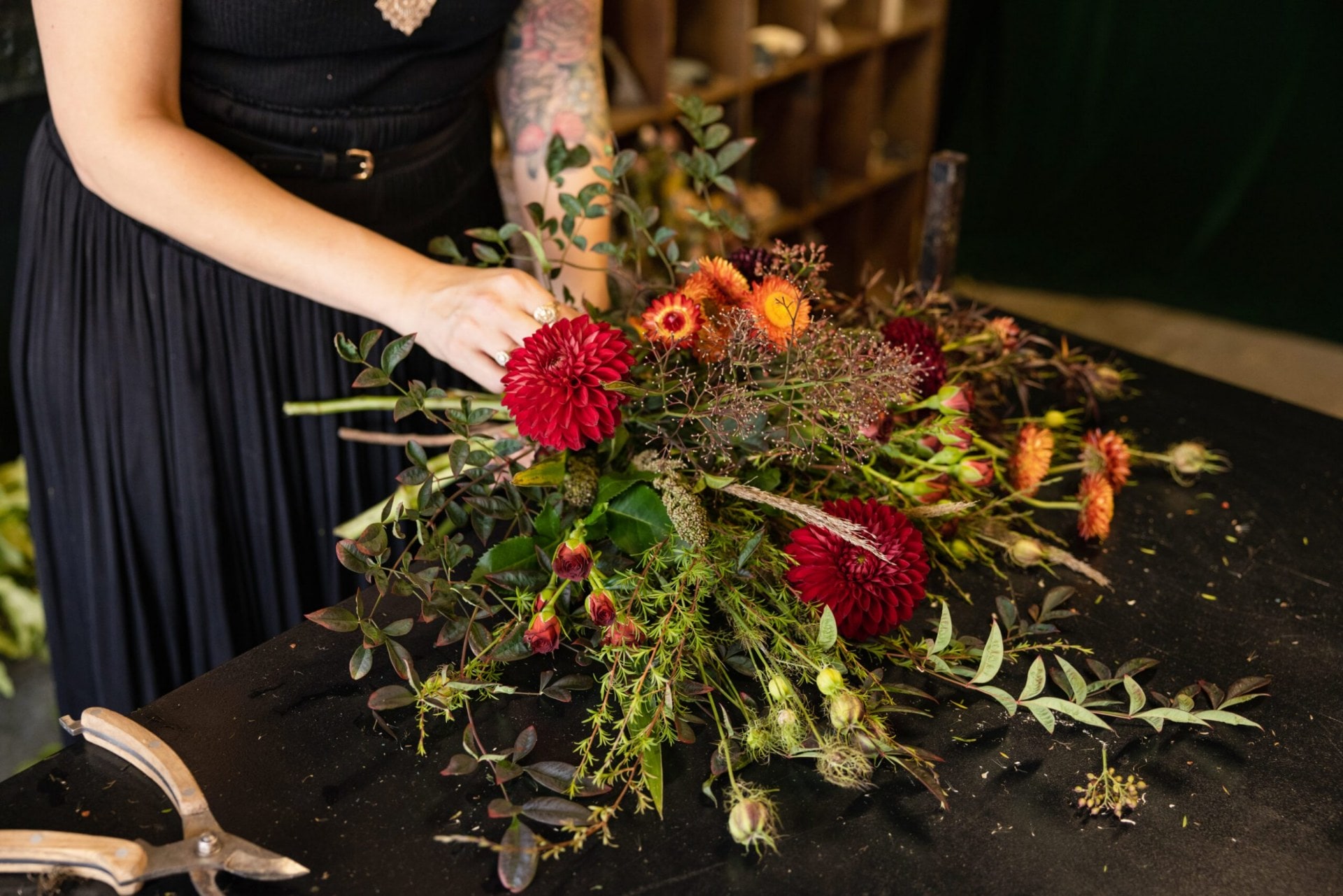 Bunch of flowers being held over a black table