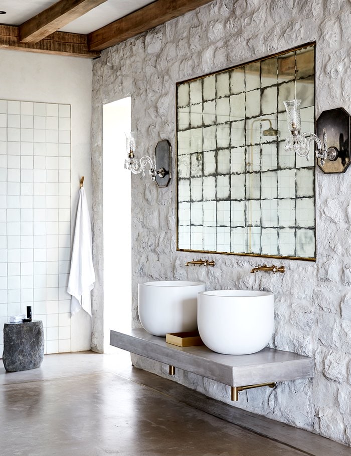 Grey industrial styled bathroom with large square vintage mirror