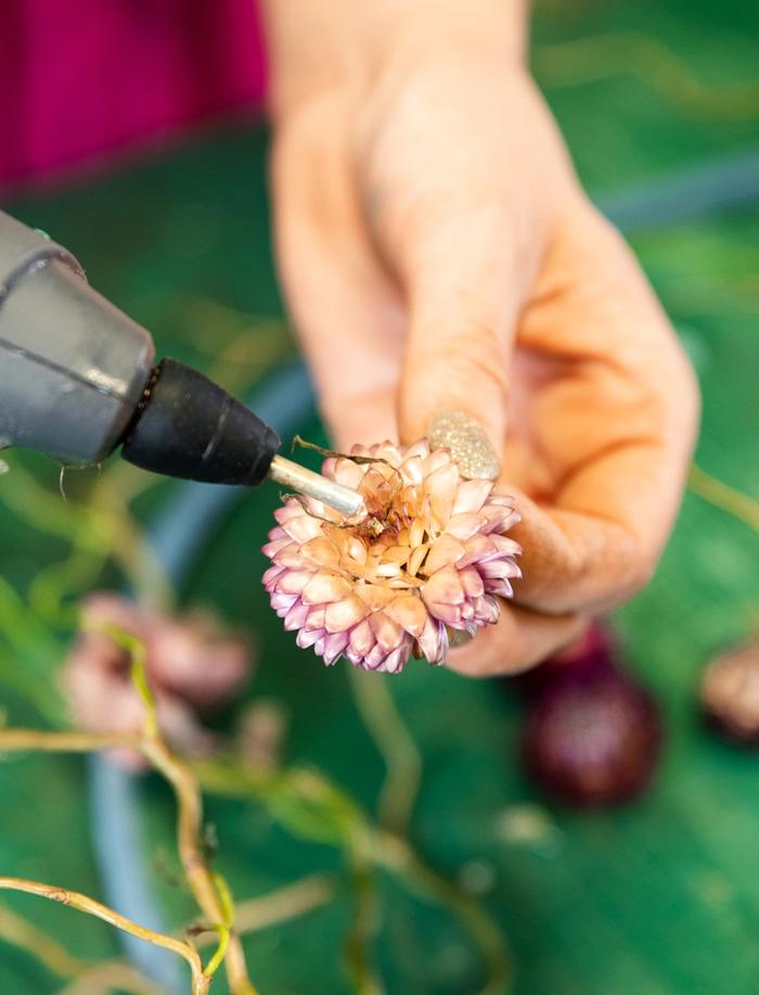 Pink and orange flower being glued