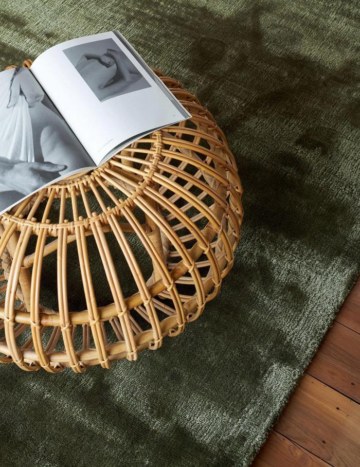Bamboo silk rug from Nodi with rattan side table on top