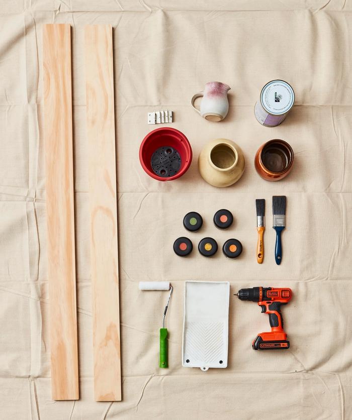 A collection of Resene paint pots and craft items laid out on a beige cloth