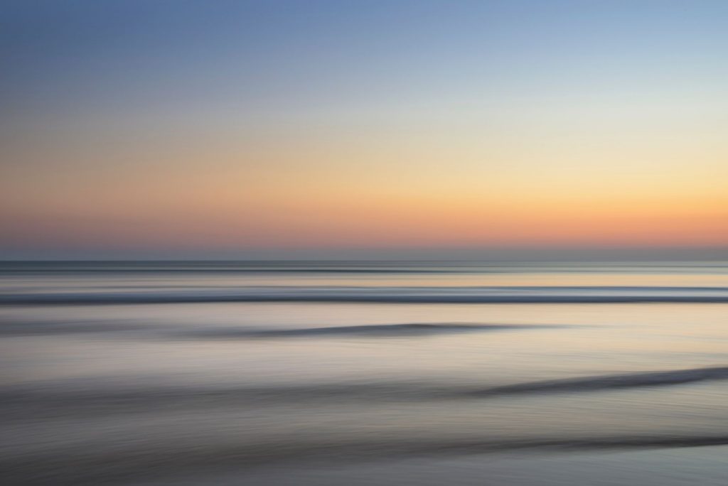 Seascape in muted colours with low sun