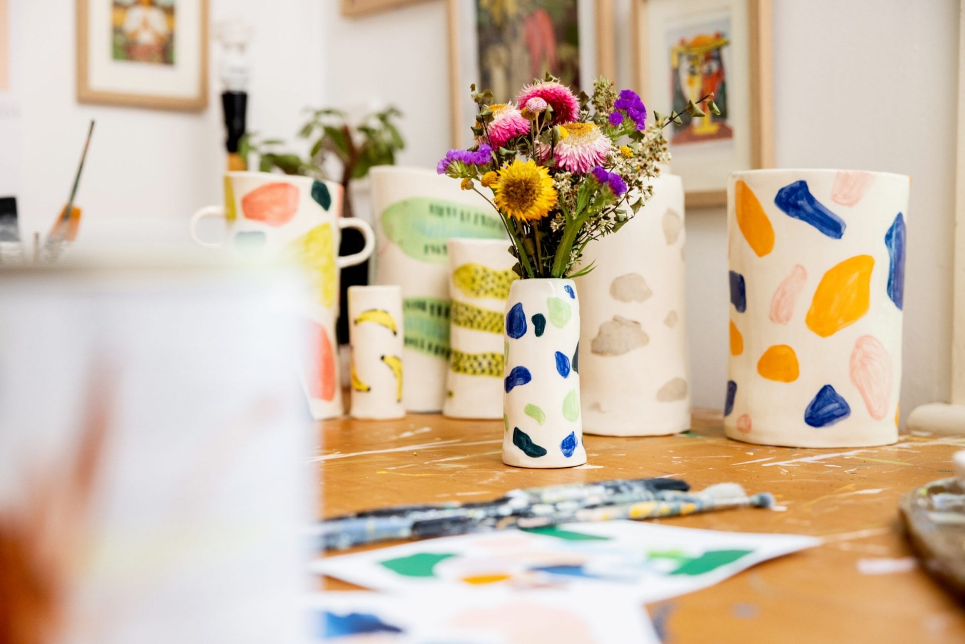 Collection of Alice Berry's ceramic vases on wooden table