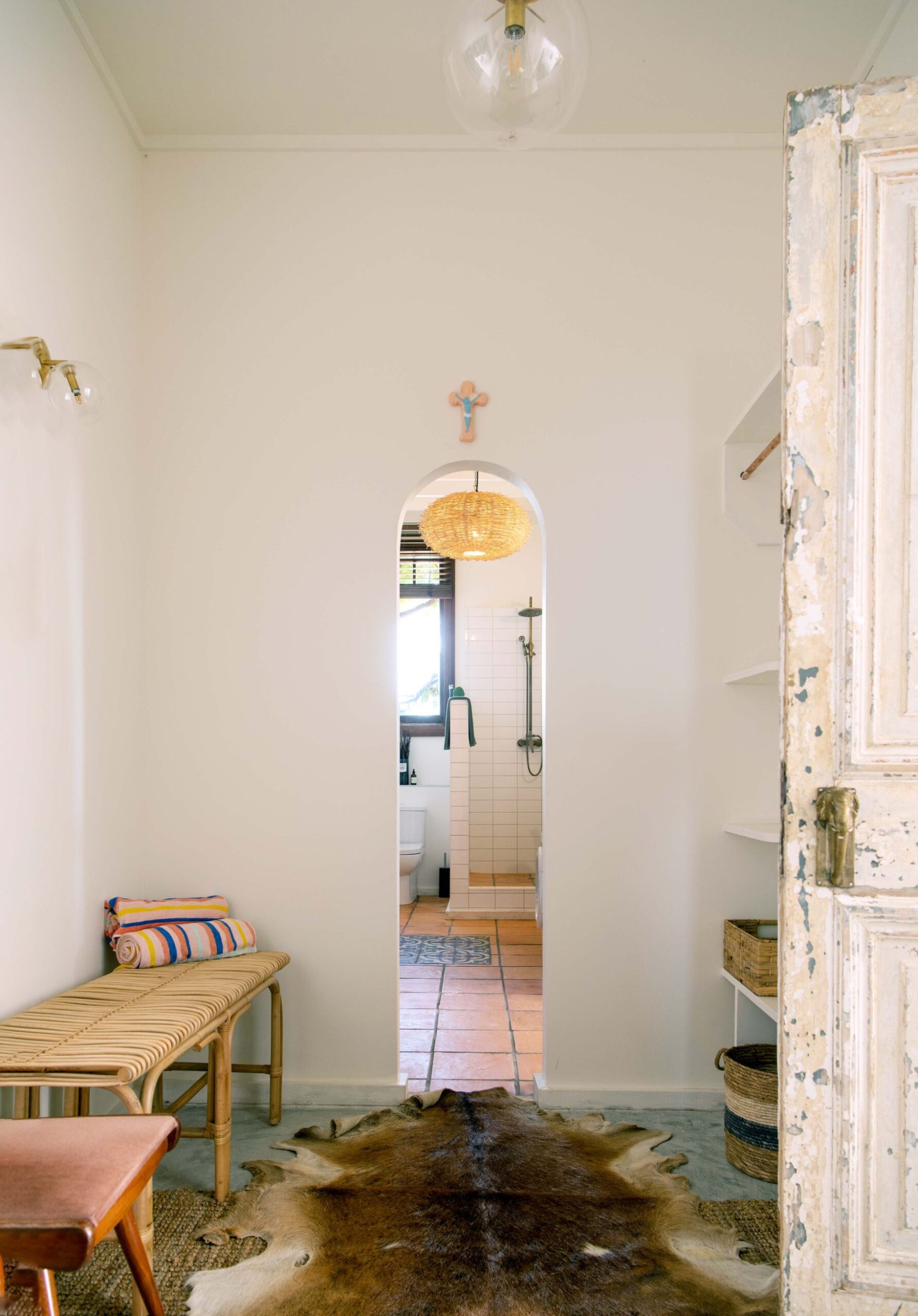 The interior of a house with an arched doorway and a vintage door