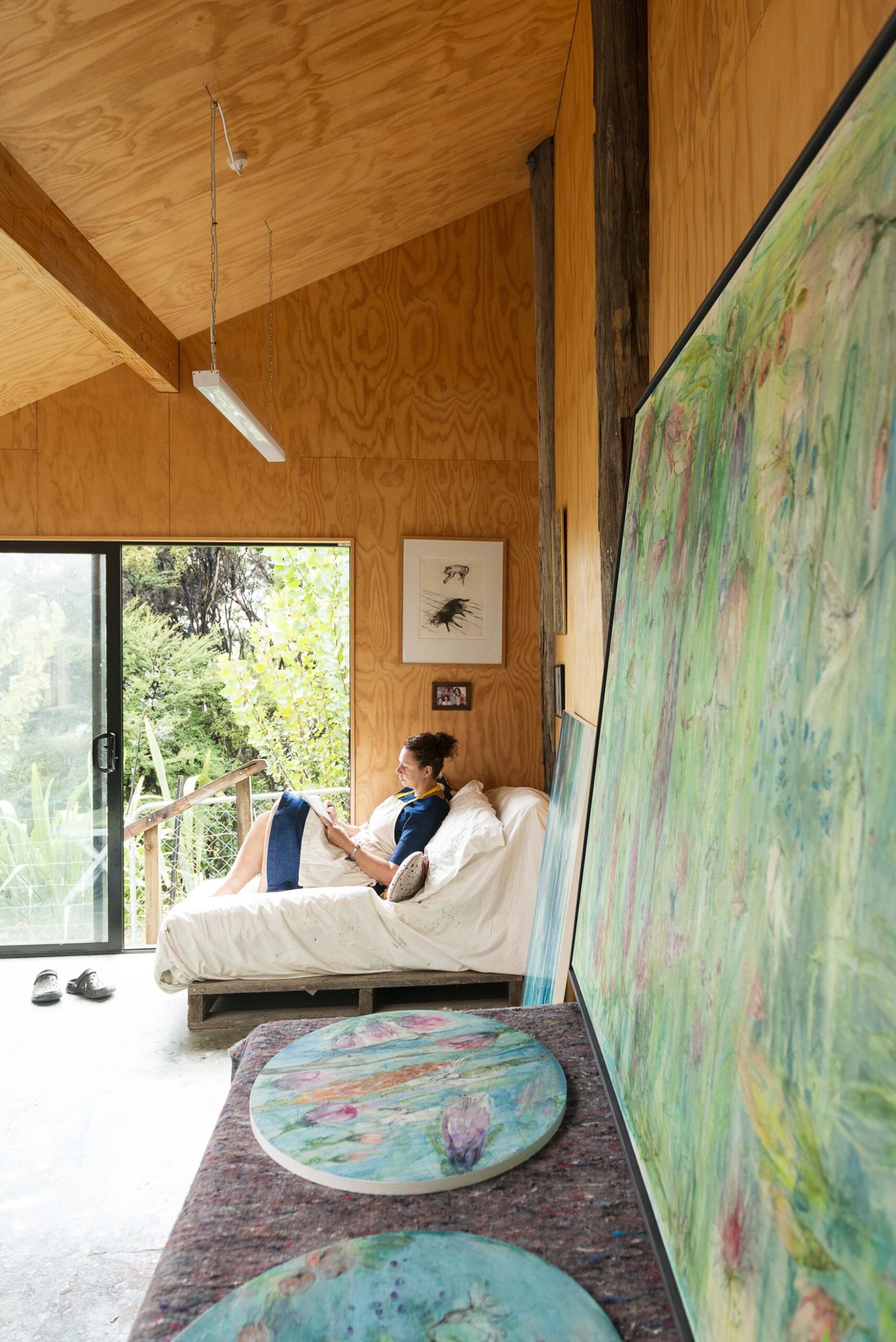 Serena Buonaguidi-Haynes sitting in her art studio surrounded by art