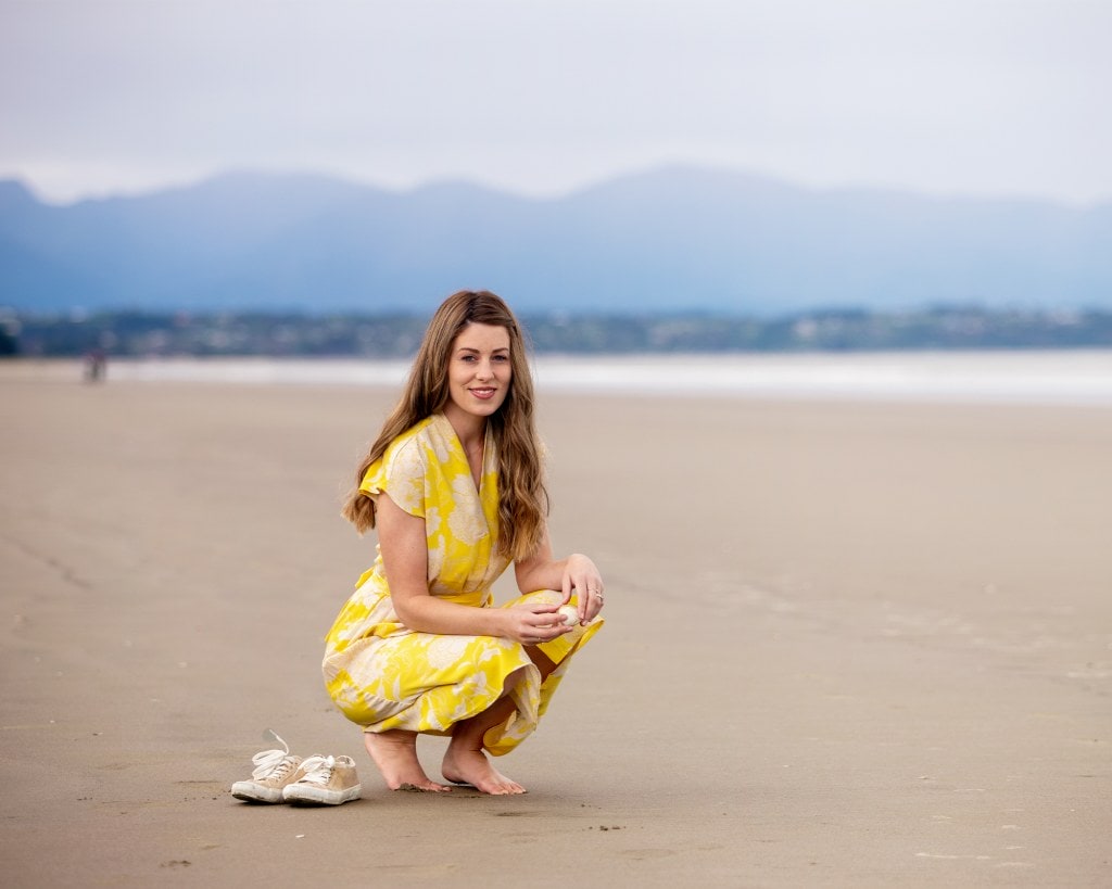 Rebecca Ballagh wearing yellow dress on beach
