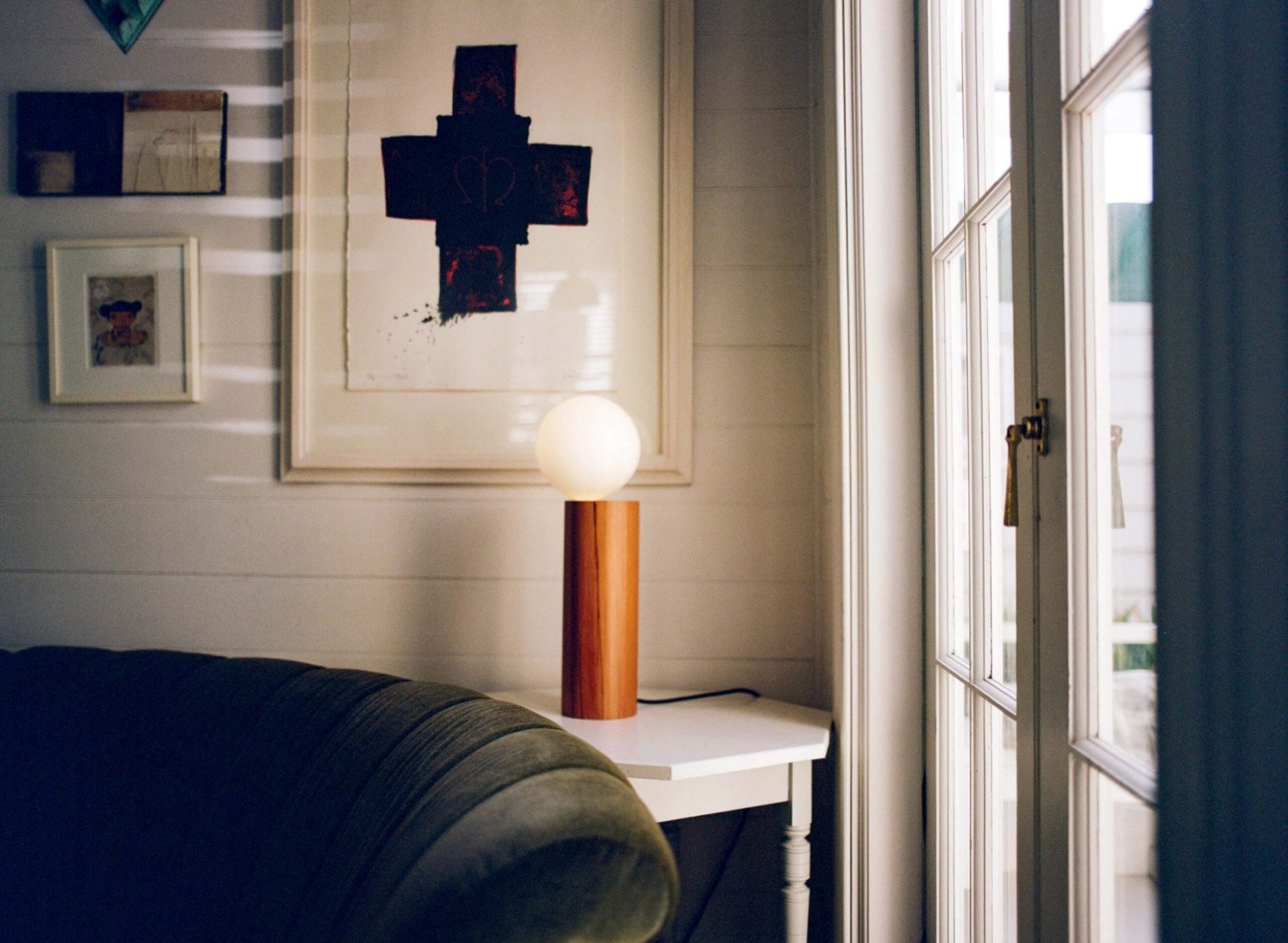 Petley's The Balanced Lamp on white table in white wooden room