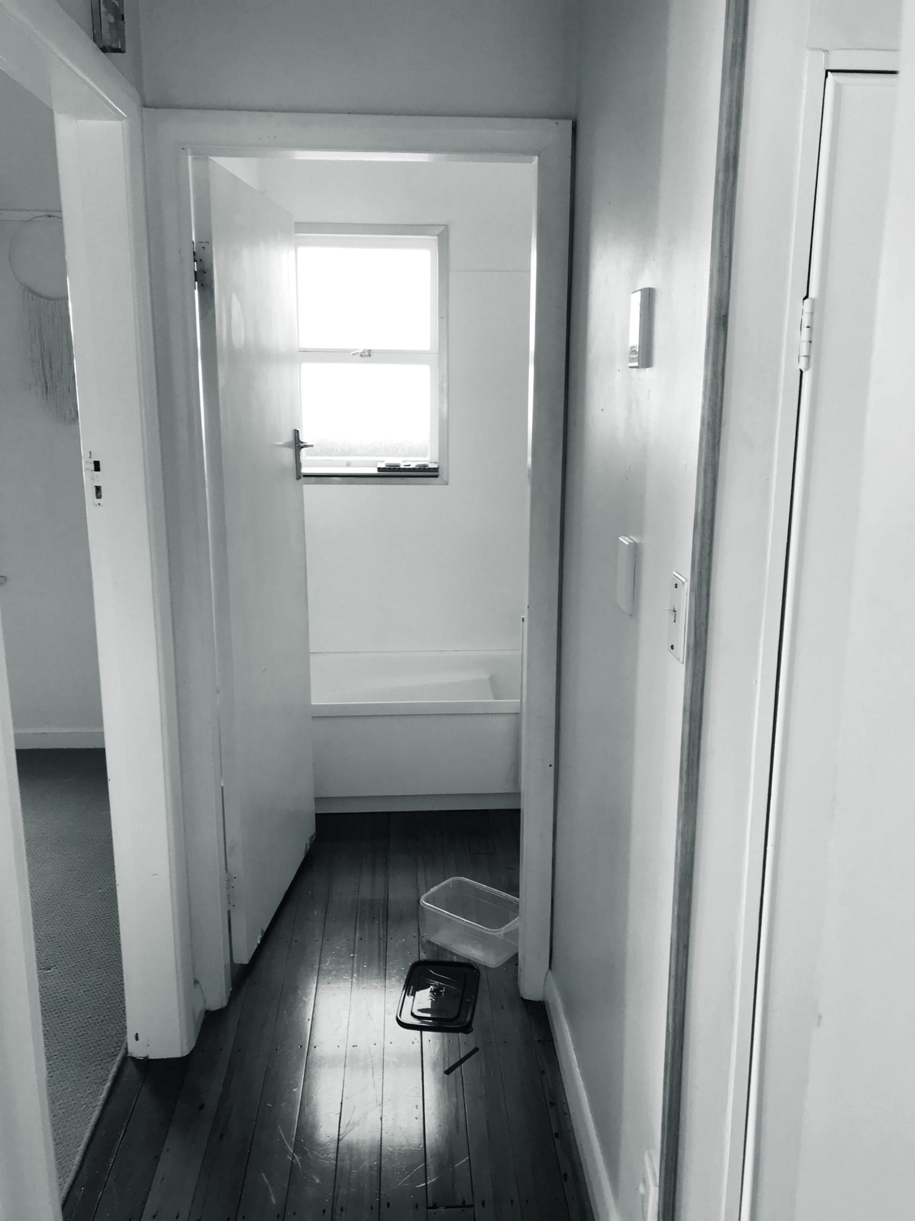 Black and white photograph of a small bathroom