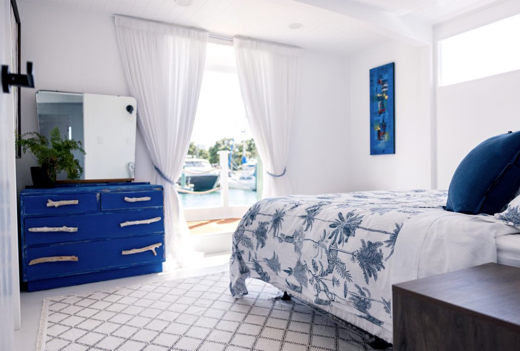 The interior of a houseboat with a blue and white theme